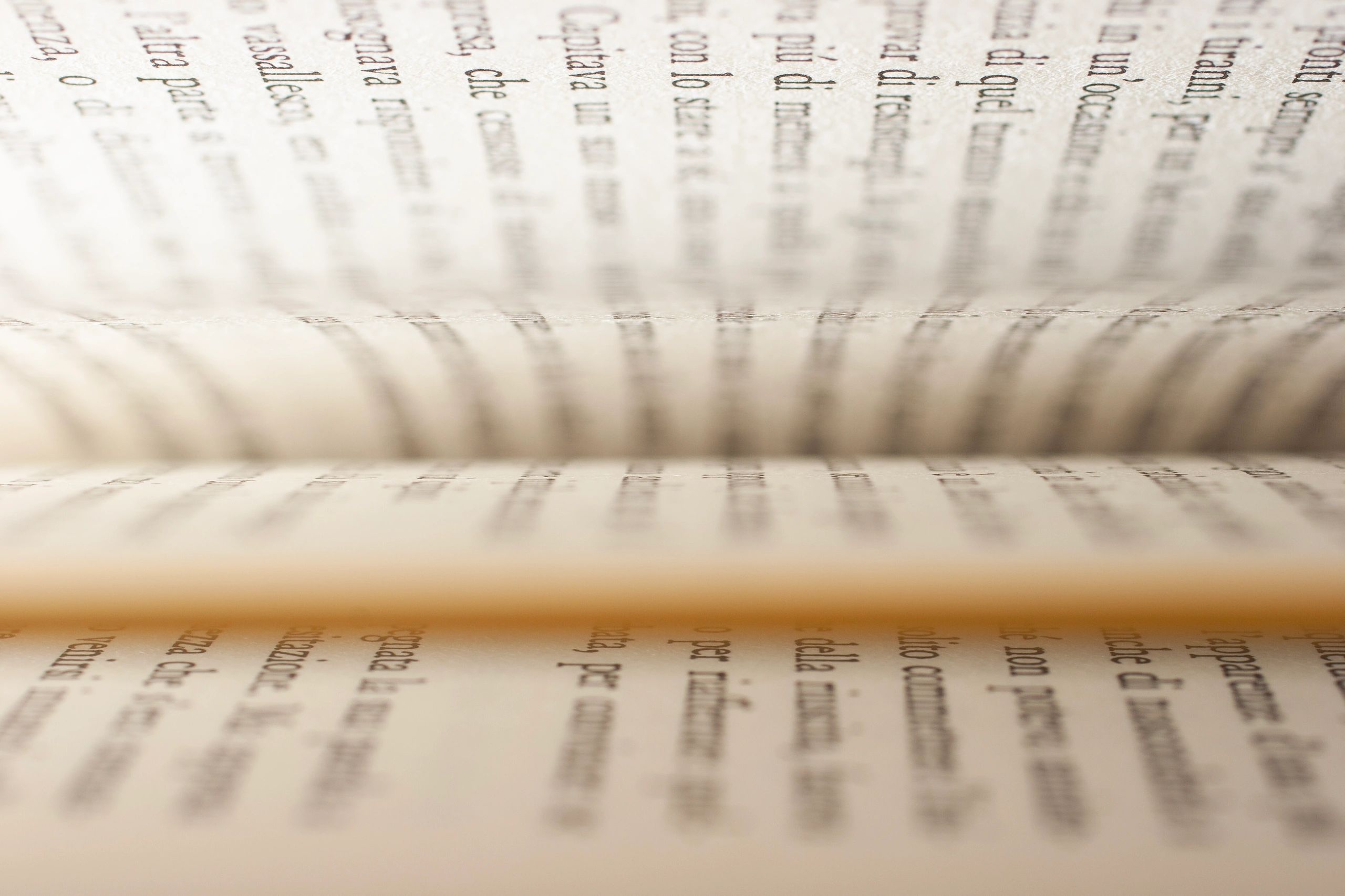 Close-up of hands turning the pages of an open book