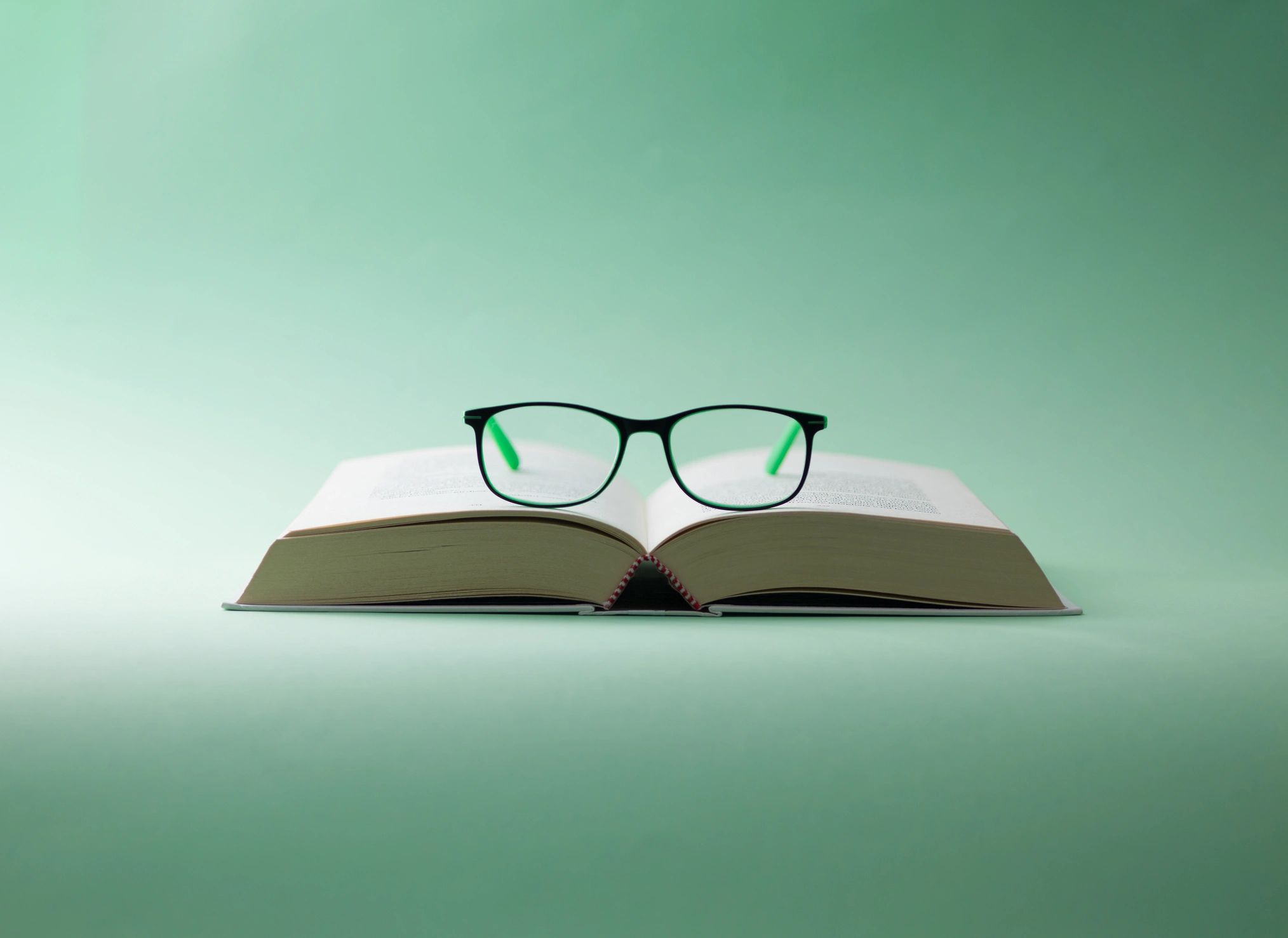 Eyeglasses resting on an open book